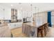 Modern kitchen boasts white cabinetry, stainless steel appliances, and a large marble island with seating at 286 Bowsprit Ct, Las Vegas, NV 89183