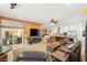 Spacious living room featuring hardwood floors, a large TV, comfortable seating, and a view of the backyard patio at 286 Bowsprit Ct, Las Vegas, NV 89183