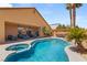 Inviting backyard pool and spa area with covered patio and outdoor seating, perfect for entertaining at 286 Bowsprit Ct, Las Vegas, NV 89183