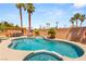 Beautiful backyard pool and spa surrounded by lush landscaping and a brick privacy wall at 286 Bowsprit Ct, Las Vegas, NV 89183