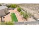 Aerial view of backyard with turf football field, inground pool, and trampoline, offering various outdoor activities at 3169 Crystal Moon Rd, Henderson, NV 89052