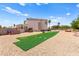 Expansive backyard features gravel landscaping, a turf field, and mountain views at 3169 Crystal Moon Rd, Henderson, NV 89052