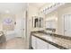 Bathroom featuring double sinks, a marble countertop, and tile flooring at 3169 Crystal Moon Rd, Henderson, NV 89052