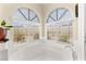 Bathtub with jets under arched windows and a view of the landscape at 3169 Crystal Moon Rd, Henderson, NV 89052