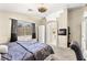 Bedroom featuring a ceiling fan, carpeted floors, and large window at 3169 Crystal Moon Rd, Henderson, NV 89052