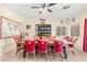 Inviting dining room featuring a wooden table, red chairs, and a built-in bookshelf at 3169 Crystal Moon Rd, Henderson, NV 89052