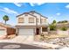 Charming two-story home featuring a two-car garage and xeriscaped front yard with a bench at 3169 Crystal Moon Rd, Henderson, NV 89052
