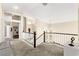 Bright hallway with neutral tones, white banister, and view of other rooms at 3169 Crystal Moon Rd, Henderson, NV 89052