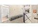 Hallway featuring gray storage bench, carpeted floors, and access to a bathroom at 3169 Crystal Moon Rd, Henderson, NV 89052