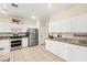 Updated kitchen featuring white cabinets, granite countertops, and stainless steel appliances at 3169 Crystal Moon Rd, Henderson, NV 89052