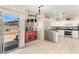 Well-lit kitchen with white cabinets, granite countertops, and view to the backyard at 3169 Crystal Moon Rd, Henderson, NV 89052