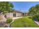 Large backyard with green grass, mature landscaping and a covered patio at 324 Quiet Harbor Dr, Henderson, NV 89052