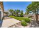 The backyard features mature trees and landscaping, concrete pavers and a grassy lawn at 324 Quiet Harbor Dr, Henderson, NV 89052