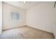 Bedroom with a window that allows natural light and neutral carpeting at 324 Quiet Harbor Dr, Henderson, NV 89052
