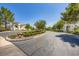 The community entrance features stone monuments, mature trees and lush landscaping at 324 Quiet Harbor Dr, Henderson, NV 89052