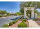 The community entrance features stone monuments, mature trees and lush landscaping at 324 Quiet Harbor Dr, Henderson, NV 89052