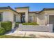 Close-up shot of home showcasing a well-manicured front yard and a stylish entryway at 324 Quiet Harbor Dr, Henderson, NV 89052