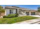 A delightful single-story home with well-kept lawn and a convenient three-car garage at 324 Quiet Harbor Dr, Henderson, NV 89052