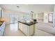 View of open kitchen featuring a center island and sliding glass doors to the backyard at 324 Quiet Harbor Dr, Henderson, NV 89052