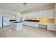 Spacious kitchen featuring white cabinetry, black countertops, and stainless steel appliances at 324 Quiet Harbor Dr, Henderson, NV 89052