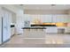 Bright kitchen with an island, white cabinets, black countertops and stainless steel appliances at 324 Quiet Harbor Dr, Henderson, NV 89052