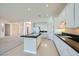 Bright kitchen featuring white cabinets, black countertops, and an open layout at 324 Quiet Harbor Dr, Henderson, NV 89052