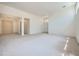 Expansive living room with neutral carpeting and stylish overhead lighting fixtures at 324 Quiet Harbor Dr, Henderson, NV 89052