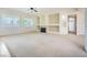 Spacious living room with a fireplace, carpeted floors, and large windows offering plenty of natural light at 324 Quiet Harbor Dr, Henderson, NV 89052