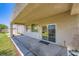 Covered patio with concrete pavers and access to the backyard and home's interior at 324 Quiet Harbor Dr, Henderson, NV 89052