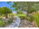 Beautiful backyard walking path through the manicured desert landscaped yard of this home at 324 Quiet Harbor Dr, Henderson, NV 89052