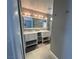 Bright bathroom featuring dual sinks, modern vanity, and sleek tile flooring at 3736 Steinbeck Dr, Las Vegas, NV 89115