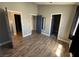 Large bedroom with multiple doors and wood flooring at 3736 Steinbeck Dr, Las Vegas, NV 89115