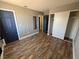 Comfortable bedroom with wood flooring, closet and blue doors at 3736 Steinbeck Dr, Las Vegas, NV 89115