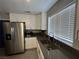 Well-lit kitchen with a stainless steel refrigerator and sink at 3736 Steinbeck Dr, Las Vegas, NV 89115
