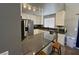 Bright kitchen featuring a gray countertop island and white cabinets at 3736 Steinbeck Dr, Las Vegas, NV 89115