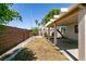 Spacious backyard featuring a covered patio, brick wall, and low-maintenance landscaping at 4439 Scarlet Sea Ave, North Las Vegas, NV 89031