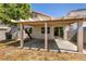 This backyard features a covered patio perfect for outdoor entertaining, plus a tree for natural shade at 4439 Scarlet Sea Ave, North Las Vegas, NV 89031