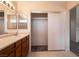 Bathroom featuring a vanity with a sink and mirrors, an open closet, and tile flooring at 4439 Scarlet Sea Ave, North Las Vegas, NV 89031