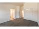 A spacious bedroom with carpeted floors, white walls, and three closets with a double door and two single doors at 4439 Scarlet Sea Ave, North Las Vegas, NV 89031