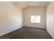 Neutral bedroom with vaulted ceilings, carpet, and a single window providing natural light at 4439 Scarlet Sea Ave, North Las Vegas, NV 89031