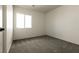 A bedroom with carpet flooring and a window to provide natural light at 4439 Scarlet Sea Ave, North Las Vegas, NV 89031