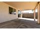 This covered patio extends the living space outdoors with a smooth concrete pad and access to the home at 4439 Scarlet Sea Ave, North Las Vegas, NV 89031