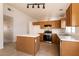 Well-lit kitchen with ample cabinet space, stainless steel appliances, and a functional island for meal preparation at 4439 Scarlet Sea Ave, North Las Vegas, NV 89031