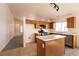 Bright kitchen featuring white countertops, ample storage, and a convenient island overlooking an adjacent living space at 4439 Scarlet Sea Ave, North Las Vegas, NV 89031