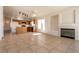 Open concept living area with a fireplace, tile flooring, and a view of the adjacent kitchen at 4439 Scarlet Sea Ave, North Las Vegas, NV 89031