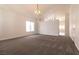 Spacious carpeted living room with natural light, neutral tones, and an open layout, creating an inviting atmosphere at 4439 Scarlet Sea Ave, North Las Vegas, NV 89031