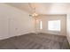 Spacious living room with lots of natural light, gray carpet and neutral walls at 4439 Scarlet Sea Ave, North Las Vegas, NV 89031