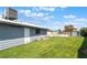 Large backyard with lush green grass, storage shed, and a sparkling private pool at 5155 Saratoga Dr, Las Vegas, NV 89120