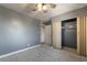 Relaxing bedroom features neutral carpeting, soothing gray walls, and sizable closet at 5155 Saratoga Dr, Las Vegas, NV 89120
