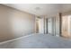 Neutral bedroom with plush carpet, bi-fold closet, and doors leading to other areas of the home at 5155 Saratoga Dr, Las Vegas, NV 89120